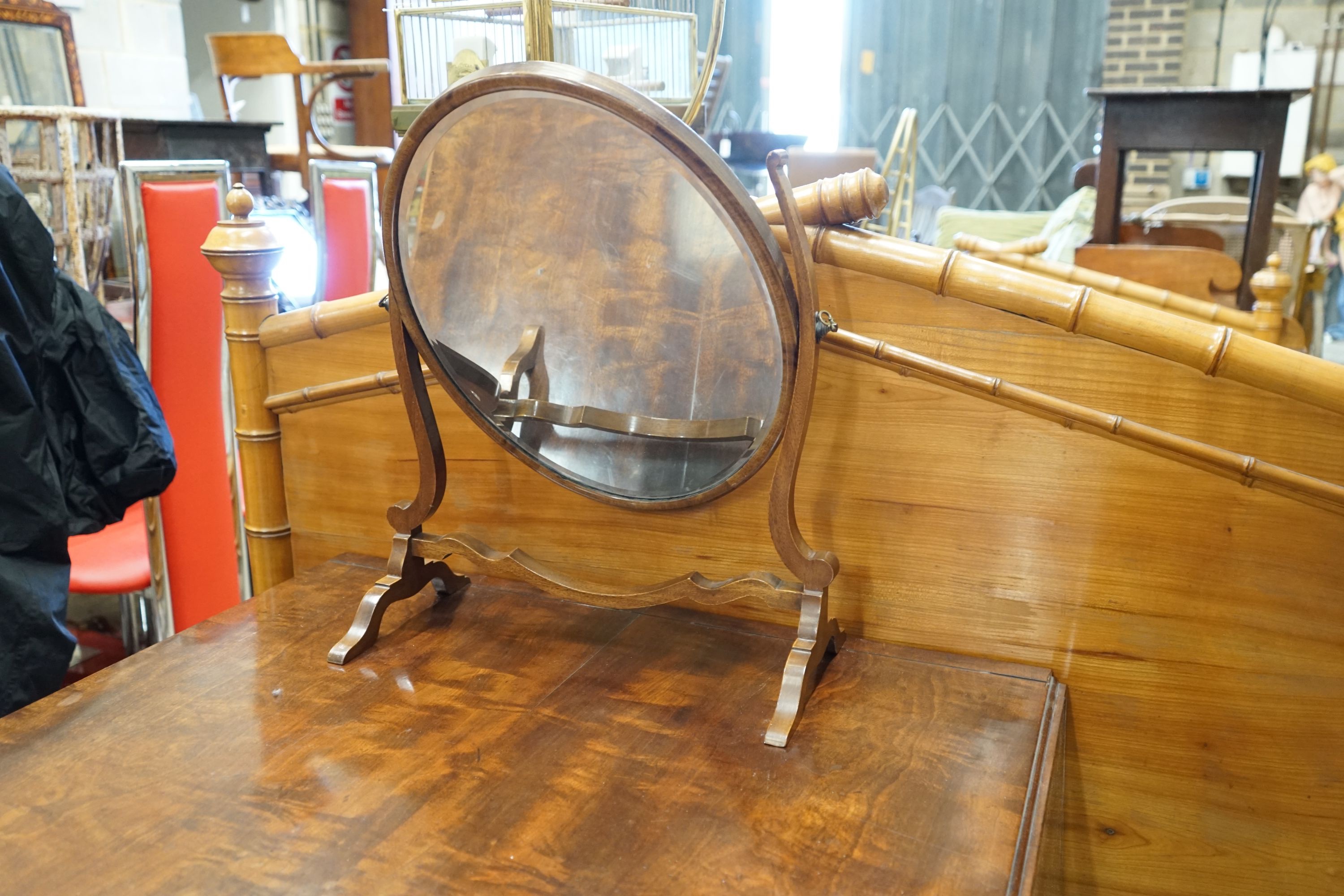 A Regency figured mahogany and ebony strung sofa table, width 83cm depth 66cm height 72cm, and a skeleton toilet mirror
